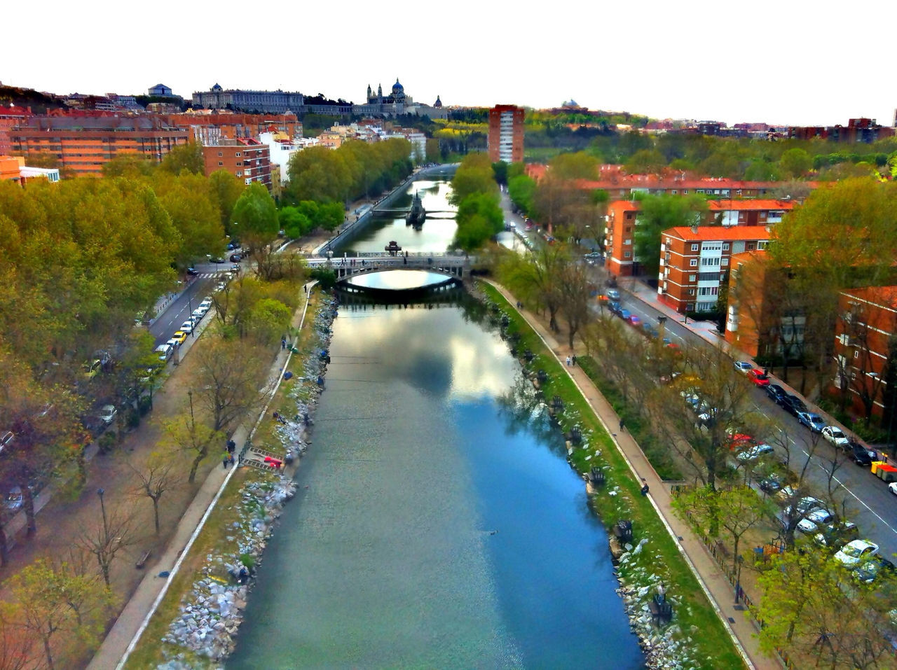 architecture, building exterior, built structure, canal, high angle view, transportation, city, water, residential building, tree, incidental people, river, residential structure, mode of transport, street, road, residential district, car, bridge - man made structure, cityscape