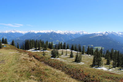 Scenic view of snowcapped mountains against blue sky