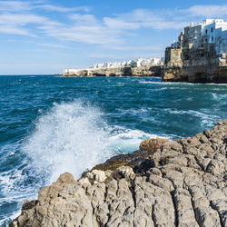 Rough and breathtaking sea. polignano a mare sunlit. puglia. italy