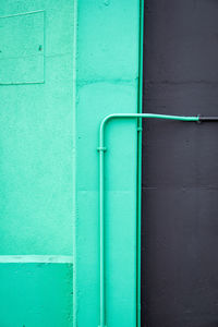 Close-up of blue pipes against wall