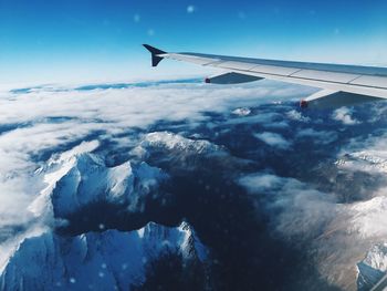Cropped image of airplane flying over landscape