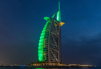 Low angle view of illuminated building against sky at night