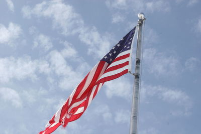 Low angle view of american flag against sky