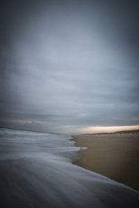Scenic view of beach against sky during sunset