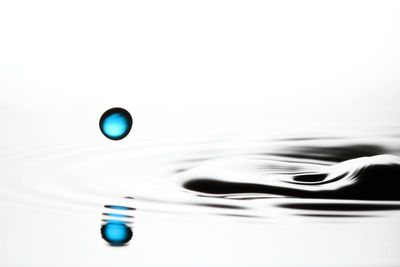 Close-up of drop falling on water surface