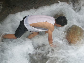 High angle view of man in stream