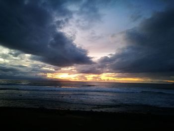 View of sea against cloudy sky during sunset