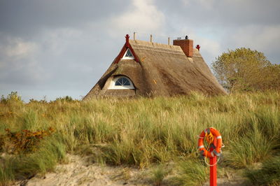 House on field against sky