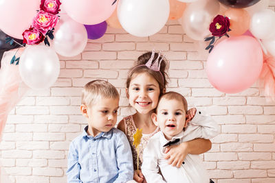 Portrait of two people with balloons