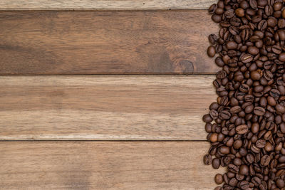 Directly above shot of roasted coffee beans on wooden table