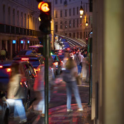 Blurred motion of people walking on street at night