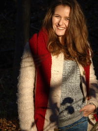 Portrait of smiling young woman standing outdoors