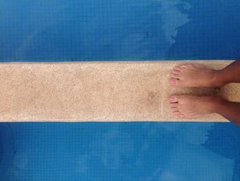 Low section of woman on swimming pool