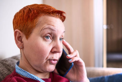 Woman talking on smart phone at home