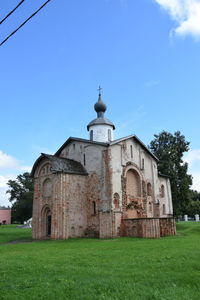 Church by building against sky