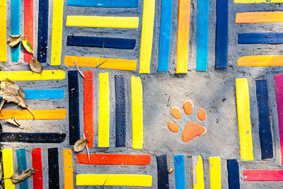 Top view on pieces of multicolored ceramic tiles decorated in garden.old pavement of tiles textured.