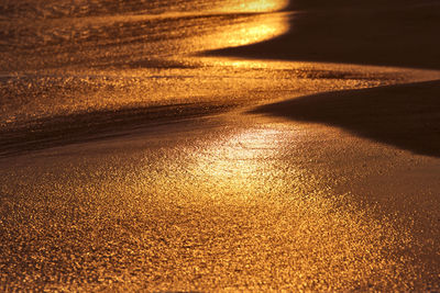 High angle view of sand at beach during sunset