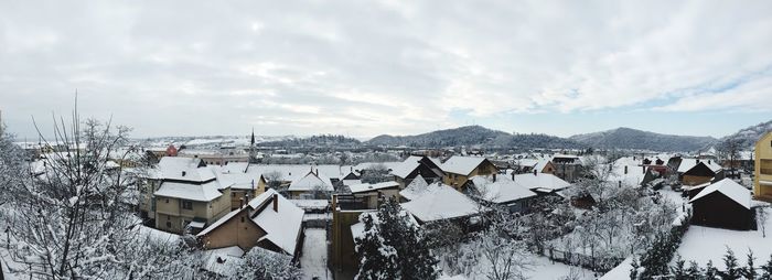 Panoramic view of buildings against sky during winter