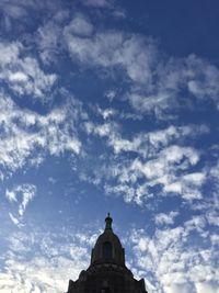 Low angle view of building against cloudy sky