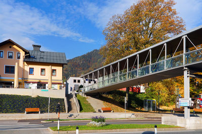 Bridge by buildings against sky in city