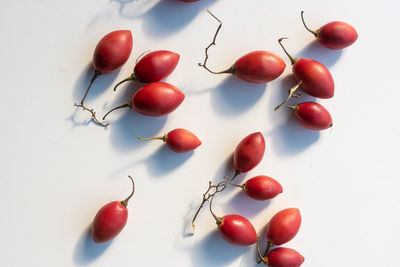 High angle view of cherry tomatoes on white background