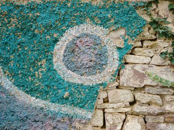 High angle view of graffiti and stone wall