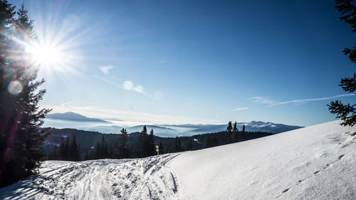 Scenic view of snow covered landscape against sky