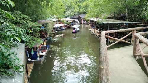 High angle view of boats in river along trees