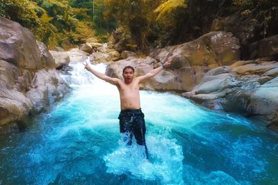 Full length of shirtless man in water