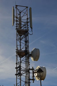 Low angle view of communications tower against sky