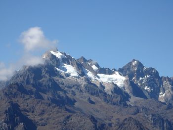 Scenic view of mountains against cloudy sky