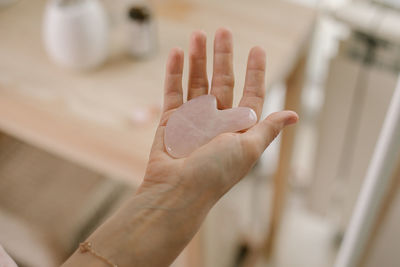 Cropped hand of woman holding jade roller