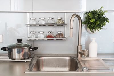 Various jars by sink in kitchen at home