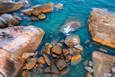 High angle view of rocks in sea