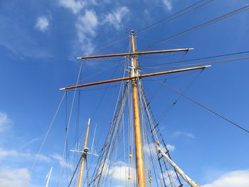 Low angle view of boat ropes against blue sky