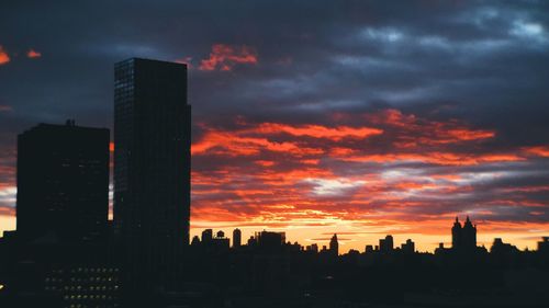 Silhouette of buildings against dramatic sky
