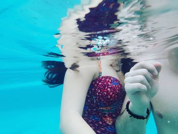 Low section of woman in swimming pool