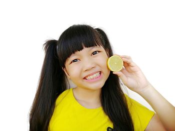 Portrait of a smiling young woman against white background