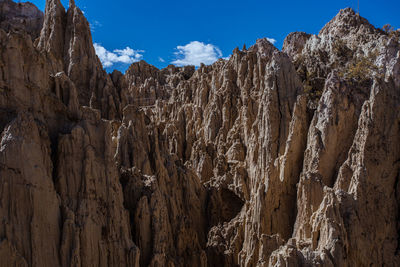 Low angle view of rock formations against sky
