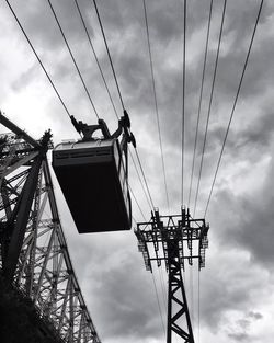 Low angle view of electricity pylon against sky