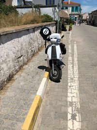 Man riding bicycle on footpath in city