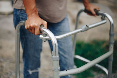 Midsection of man holding bicycle