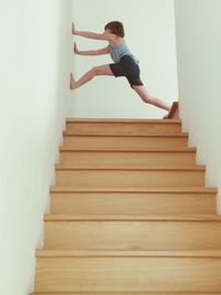 Full length of woman standing by railing