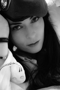 Close-up portrait of young woman wearing hat