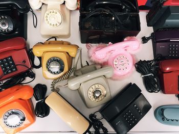 High angle view of various landline phones on table