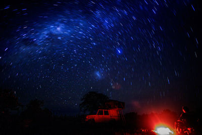 Low angle view of fireworks against sky at night