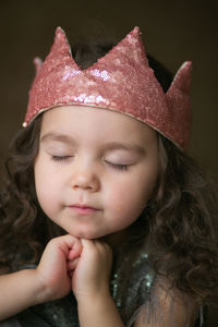 Close-up portrait of cute girl with eyes closed