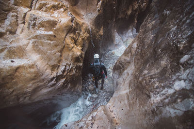 Full length of man on rock in cave