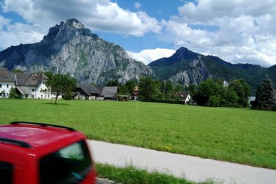 Scenic view of mountains against cloudy sky