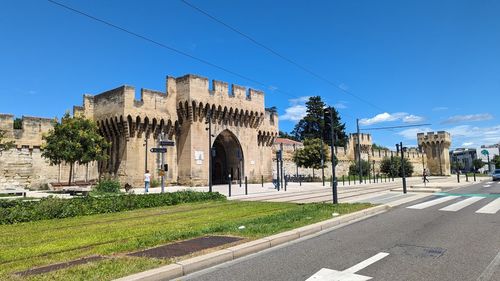 Buildings in city against clear blue sky